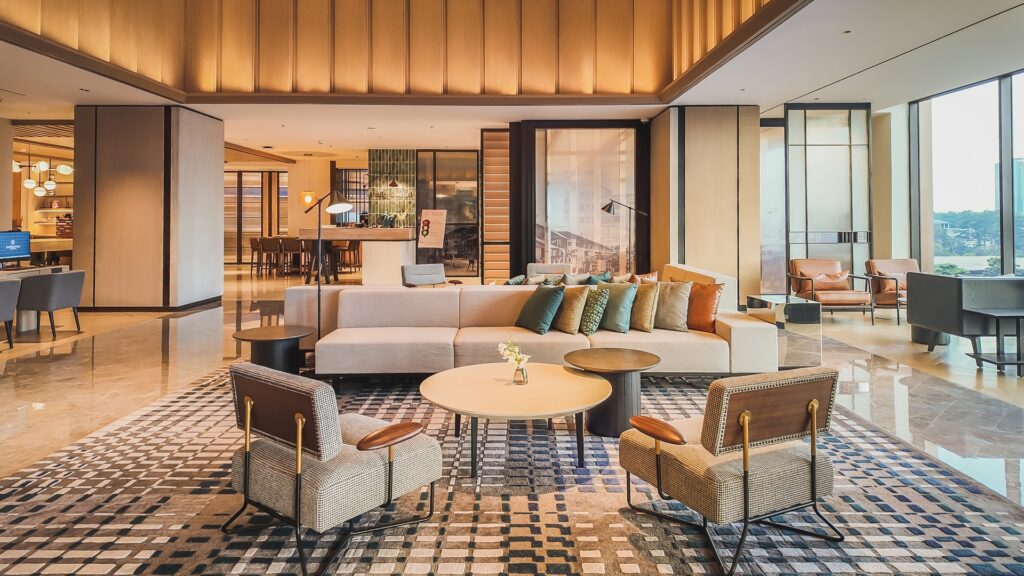 Sheraton Johor Bahru lobby featuring soaring ceilings, expansive space, and Scandinavian-inspired warm wood textures.
