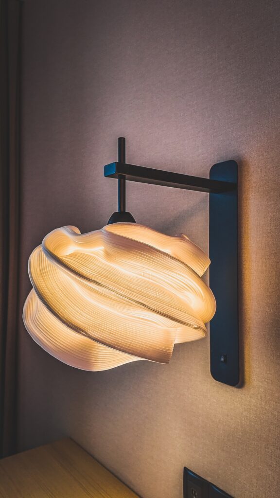 Textured bedside lamps in an Amari Kuala Lumpur guestroom, adding warmth and artistic elegance to the space.