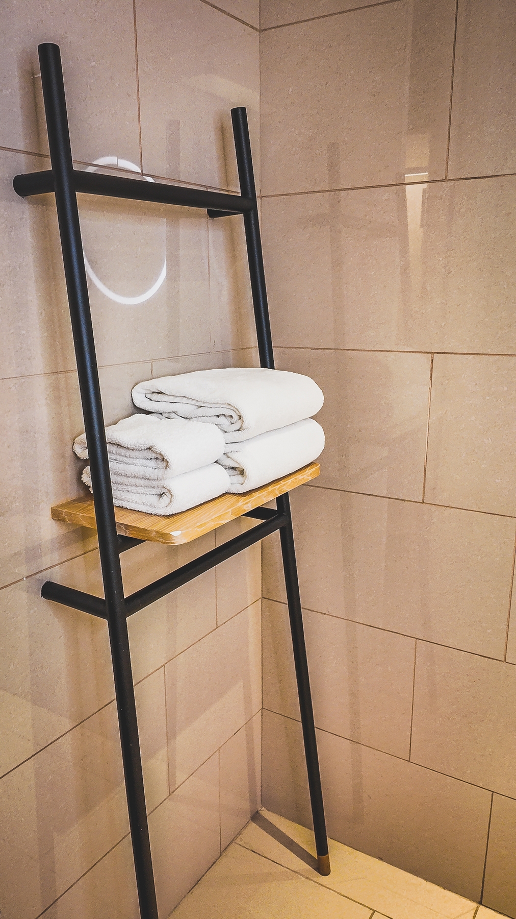 Multi-tier hanging racks in an Amari Kuala Lumpur guestroom, offering organized and stylish storage for clothing and accessories